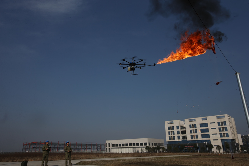 Electric company maintenance workers in Xiangyang, China used a fire-shooting drone to burn garbage from electrical wires (Photo by Wang Hu/VCG)